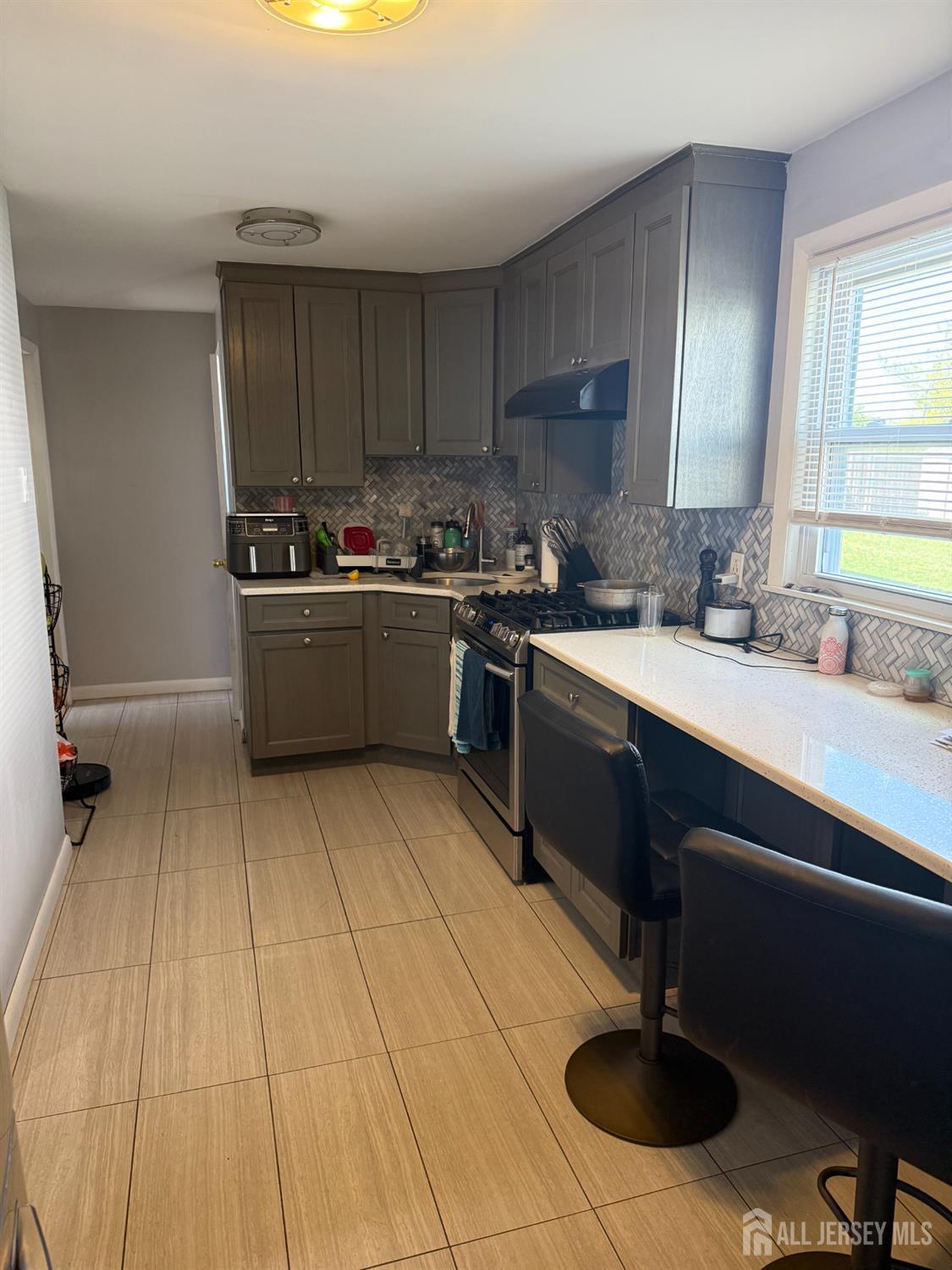 31 Edwin Street Carteret, NJ 07008 - Photo 13 of 18 a kitchen with stainless steel appliances granite countertop a sink and cabinets