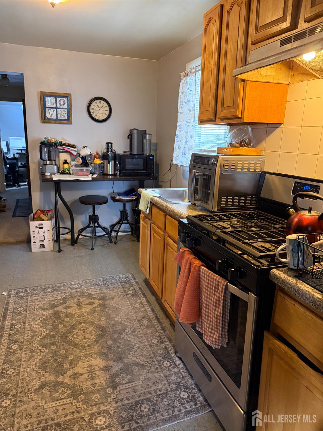 31 Edwin Street Carteret, NJ 07008 - Photo 18 of 18 a kitchen with a stove and a refrigerator