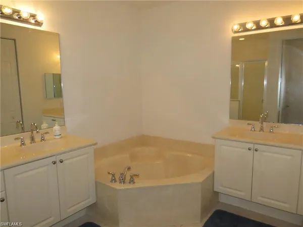 a bedroom with a bed and with furniture