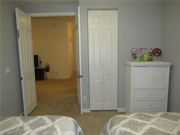 a bedroom with two beds and a window