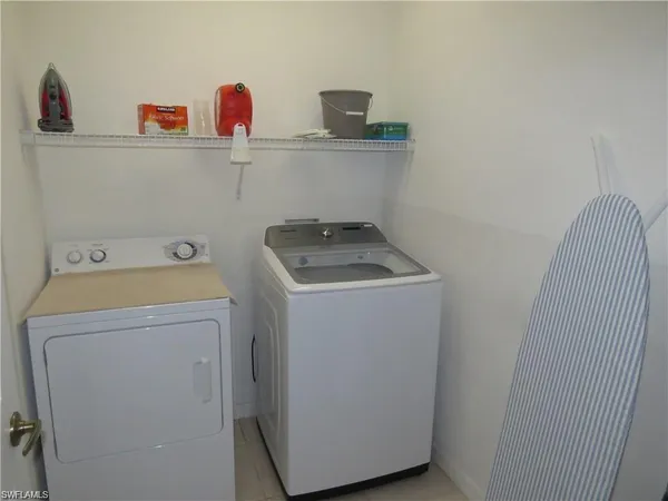 a bedroom with a bed and utility room