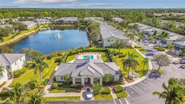 an aerial view of residential houses with outdoor space and lake view