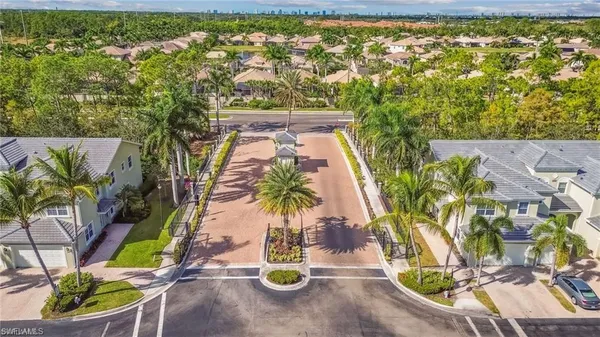 an aerial view of residential houses with outdoor space and swimming pool