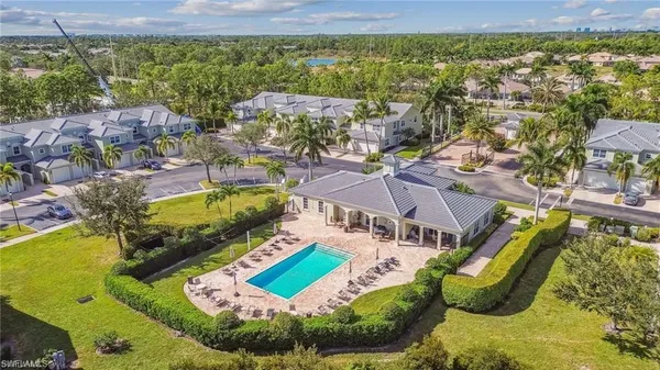 an aerial view of residential houses with outdoor space and swimming pool