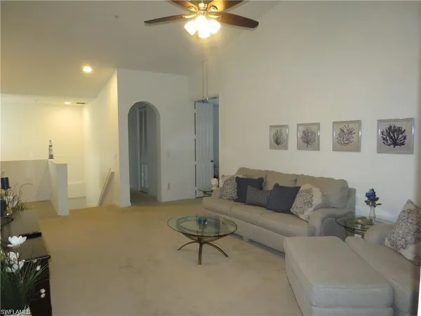 a living room with furniture and a chandelier