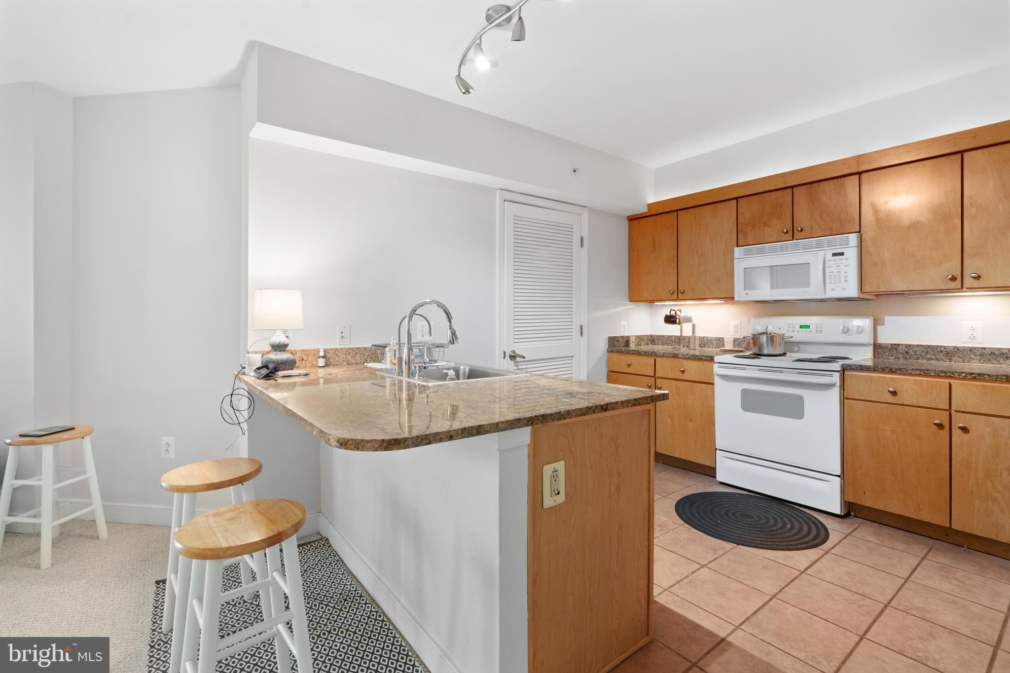 616 E Street Northwest, Unit 304 Washington, DC 20004 - Photo 19 of 53 a kitchen with a sink cabinets and a window