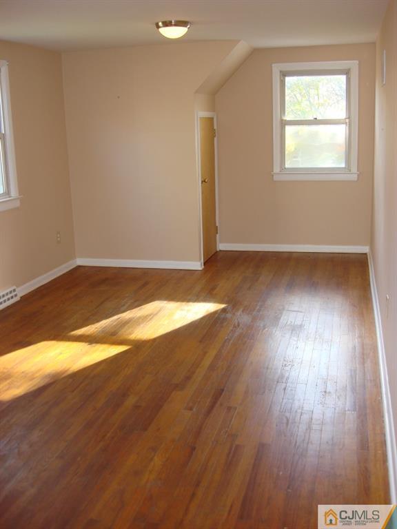 198 Opossum Road Skillman, NJ 08558 - Photo 13 of 25 an empty room with wooden floor and windows