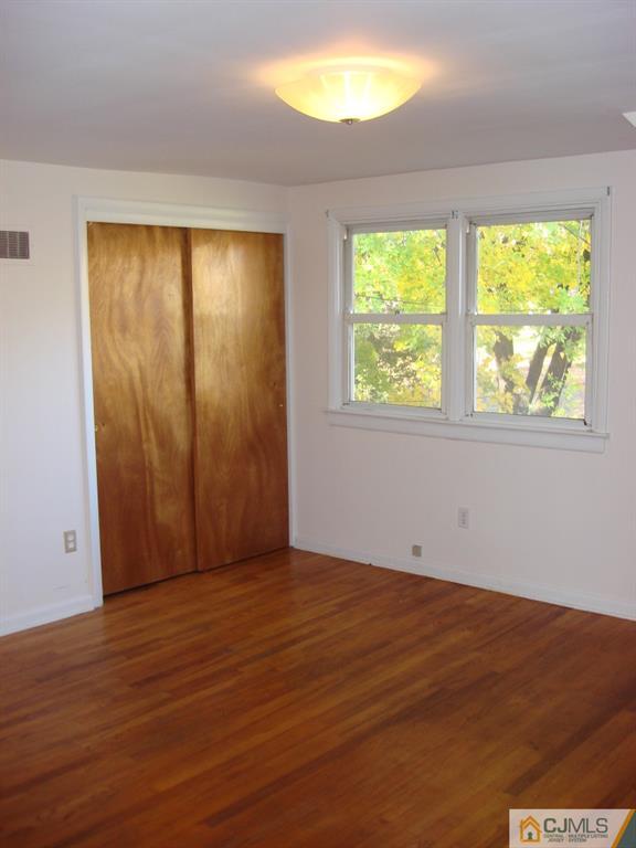 198 Opossum Road Skillman, NJ 08558 - Photo 14 of 25 a view of an empty room with wooden floor and a window
