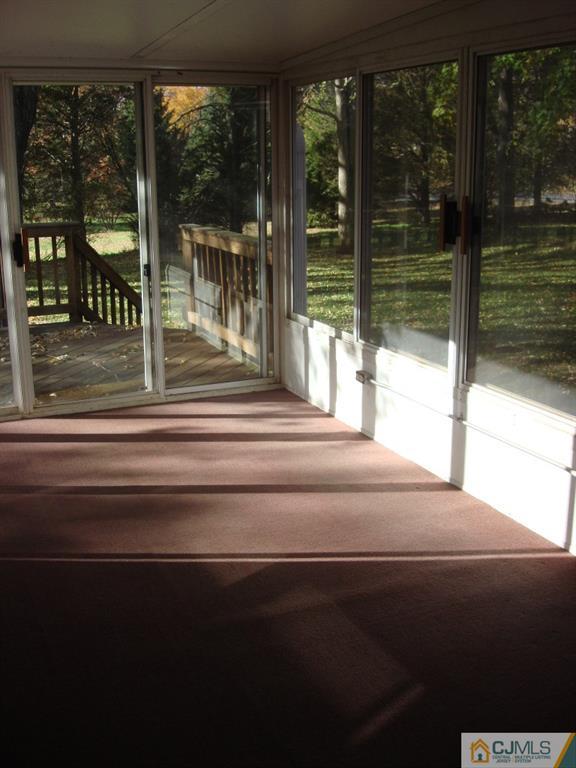 198 Opossum Road Skillman, NJ 08558 - Photo 23 of 25 a living room with a floor to ceiling window and garden