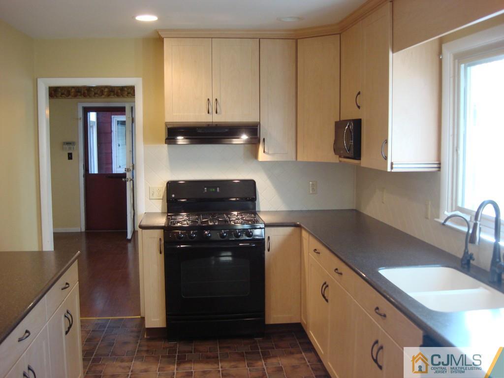 198 Opossum Road Skillman, NJ 08558 - Photo 5 of 25 a kitchen with stainless steel appliances granite countertop a stove a sink and a microwave
