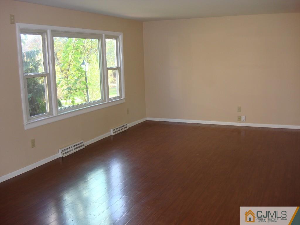 198 Opossum Road Skillman, NJ 08558 - Photo 9 of 25 an empty room with wooden floor and windows