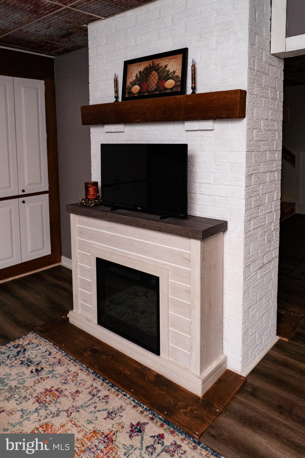 420 Locust Street Burnham, PA 17009 - Photo 13 of 59 a living room with a fireplace and a flat screen tv