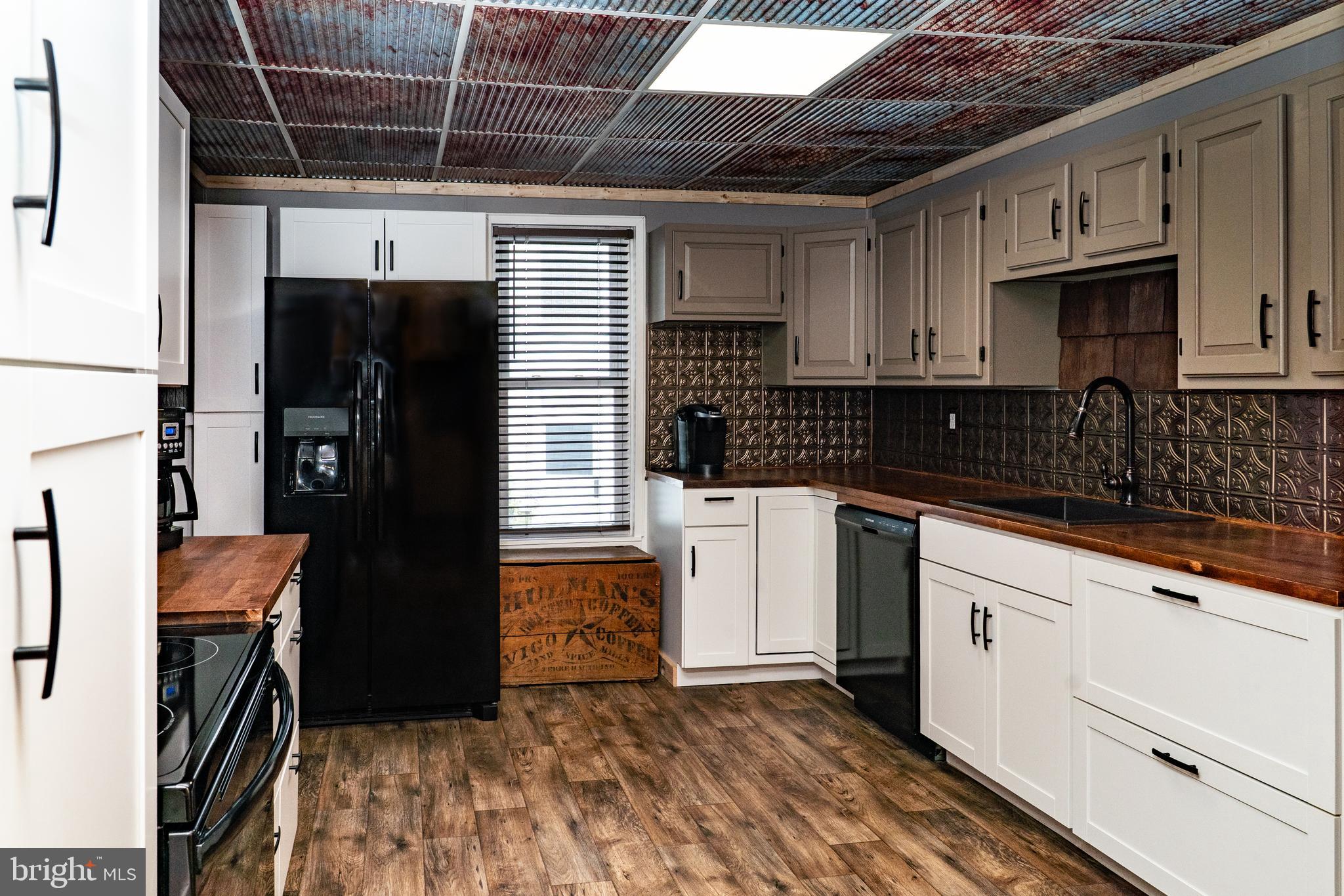 420 Locust Street Burnham, PA 17009 - Photo 22 of 59 a kitchen with stainless steel appliances granite countertop a refrigerator and a sink