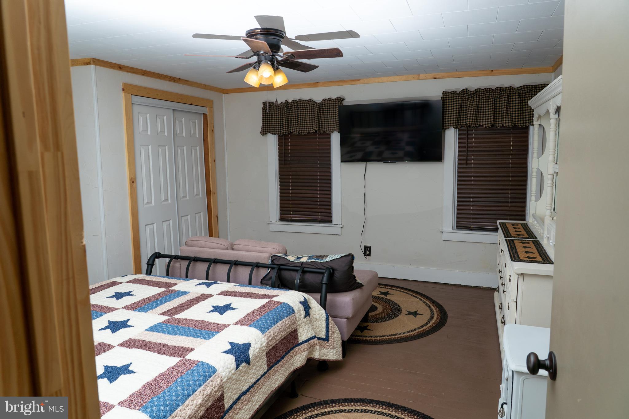 420 Locust Street Burnham, PA 17009 - Photo 33 of 59 a bedroom with a bed and a chandelier