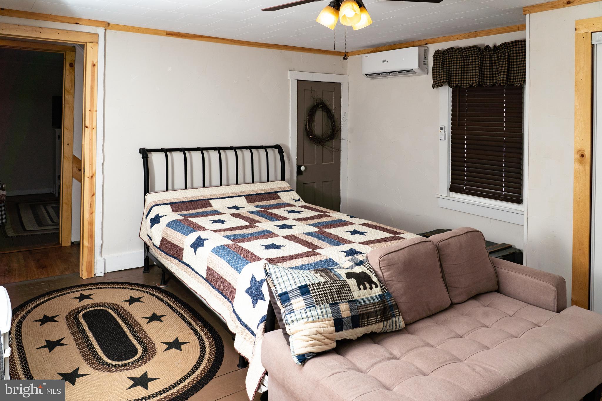 420 Locust Street Burnham, PA 17009 - Photo 34 of 59 a bedroom with a bed and a chandelier