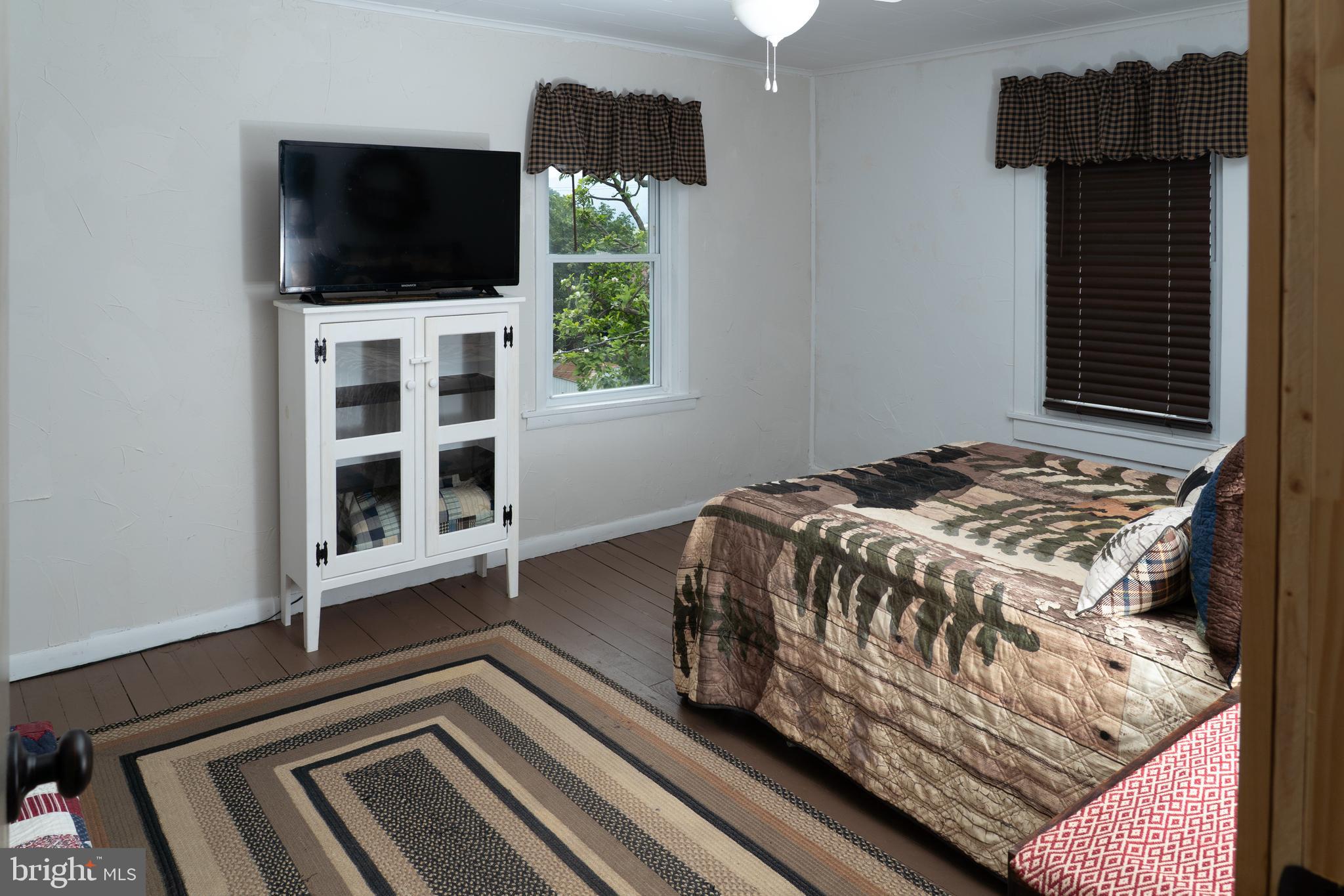 420 Locust Street Burnham, PA 17009 - Photo 35 of 59 a bedroom with a bed and a flat tv screen