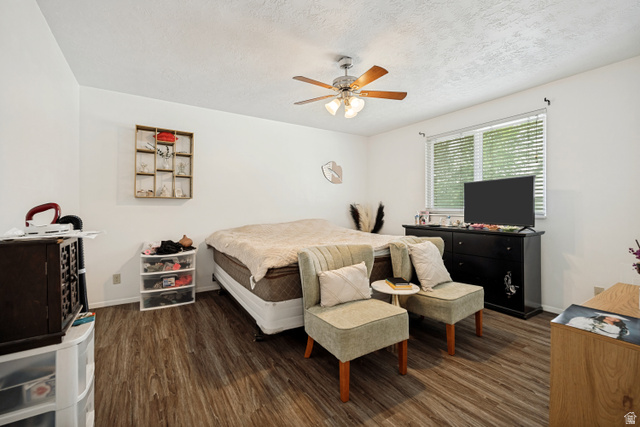 6709 Acoma Road, Unit 239 Midvale, UT 84047 - Photo 9 of 38 6711 - Main Level Bedroom1. Wood-finish flooring, ceiling fan, white walls, and a window with blinds