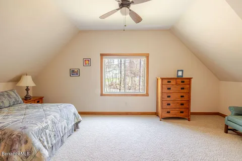 a bedroom with a bed and a ceiling fan