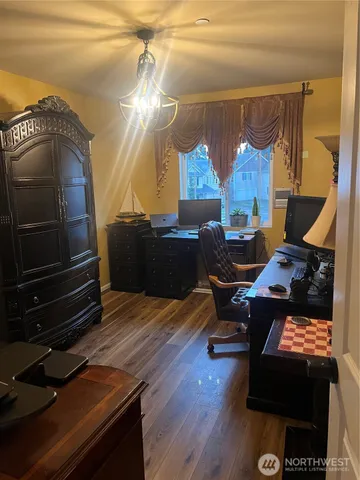 a living room with furniture and a lamp