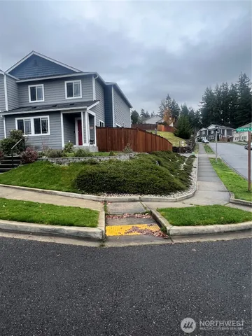 a view of house with a yard and plants