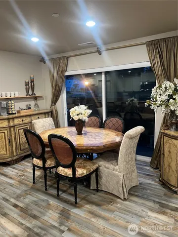 a outdoor dining space with furniture and wooden floor