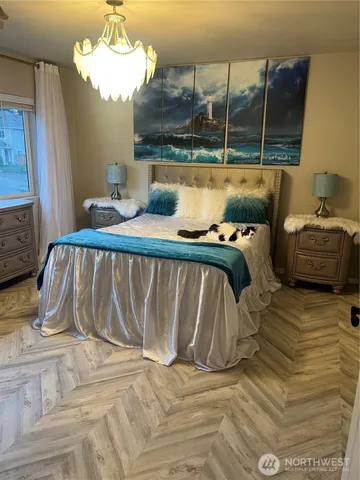 a bed sitting in a bedroom next to a window