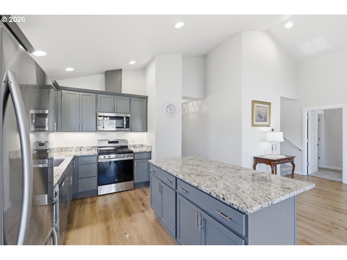 2046 Southeast Academy Street Dallas, OR 97338 - Photo 14 of 47 a kitchen with stainless steel appliances granite countertop a stove refrigerator and a sink