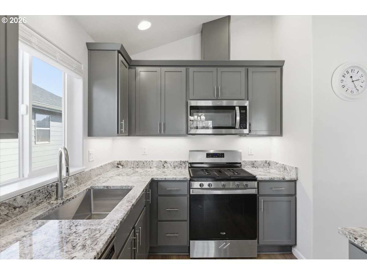 2046 Southeast Academy Street Dallas, OR 97338 - Photo 15 of 47 a kitchen with a sink stove top oven and cabinets