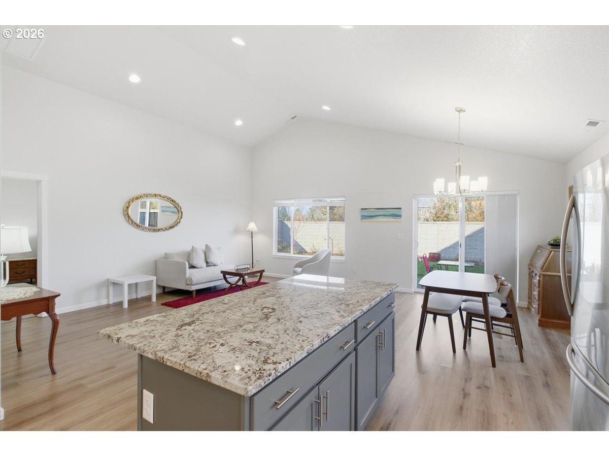 2046 Southeast Academy Street Dallas, OR 97338 - Photo 19 of 47 a kitchen with granite countertop kitchen island stainless steel appliances a dining table and chairs