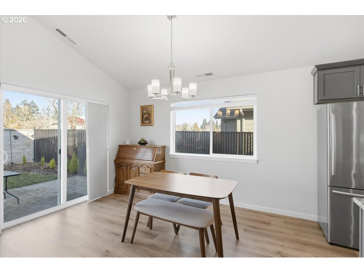 2046 Southeast Academy Street Dallas, OR 97338 - Photo 20 of 47 a view of a dining room with furniture a chandelier and wooden floor