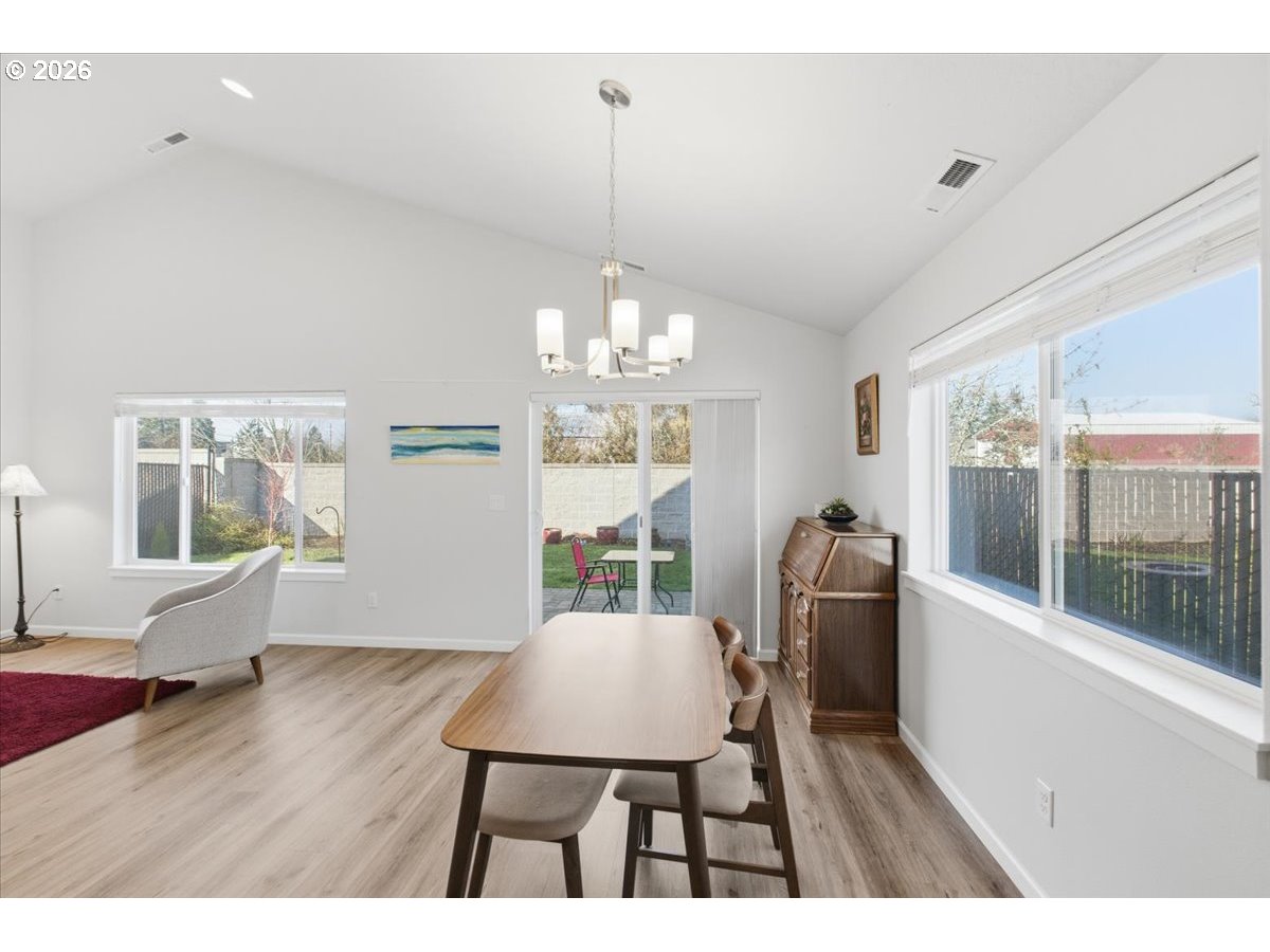 2046 Southeast Academy Street Dallas, OR 97338 - Photo 21 of 47 a view of a dining room with furniture wooden floor and a chandelier