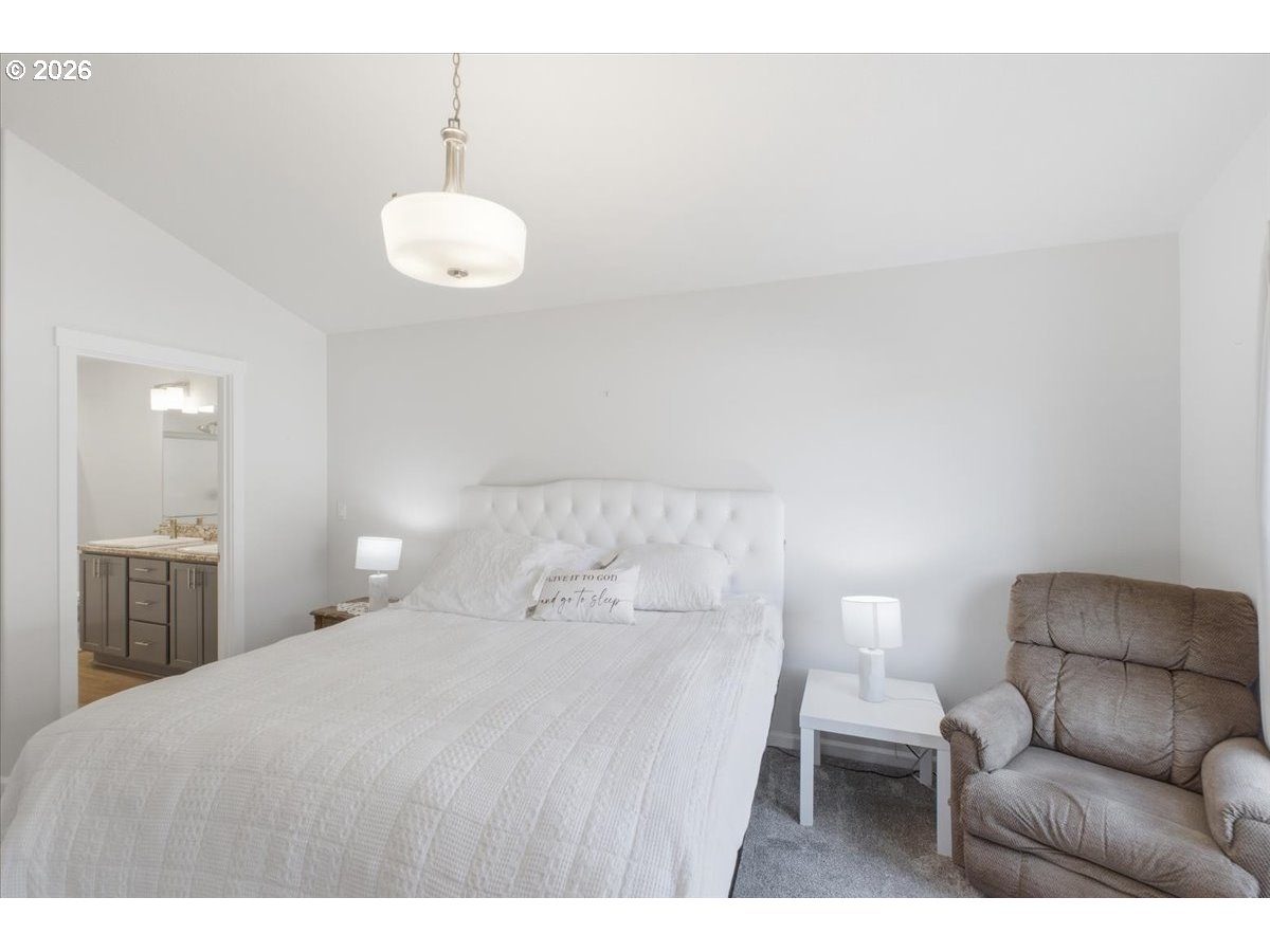 2046 Southeast Academy Street Dallas, OR 97338 - Photo 23 of 47 a bedroom with a bed and chandelier