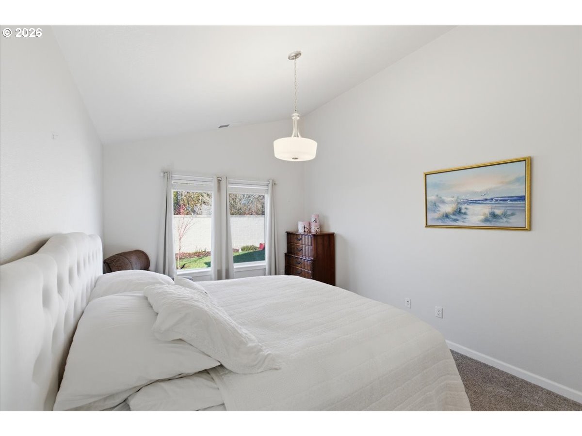 2046 Southeast Academy Street Dallas, OR 97338 - Photo 24 of 47 a bedroom with a bed and a painting on the wall