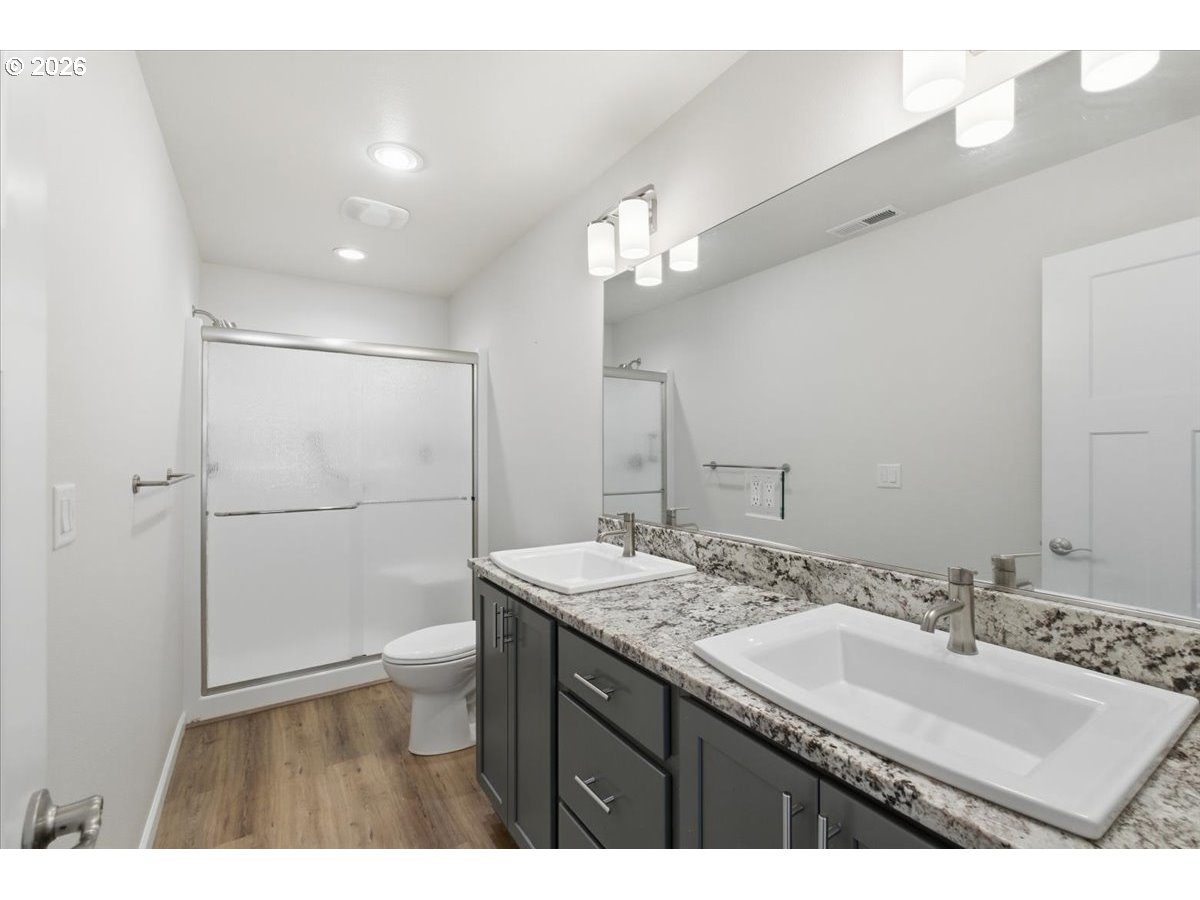 2046 Southeast Academy Street Dallas, OR 97338 - Photo 25 of 47 a bathroom with a sink double vanity granite tub shower and a mirror