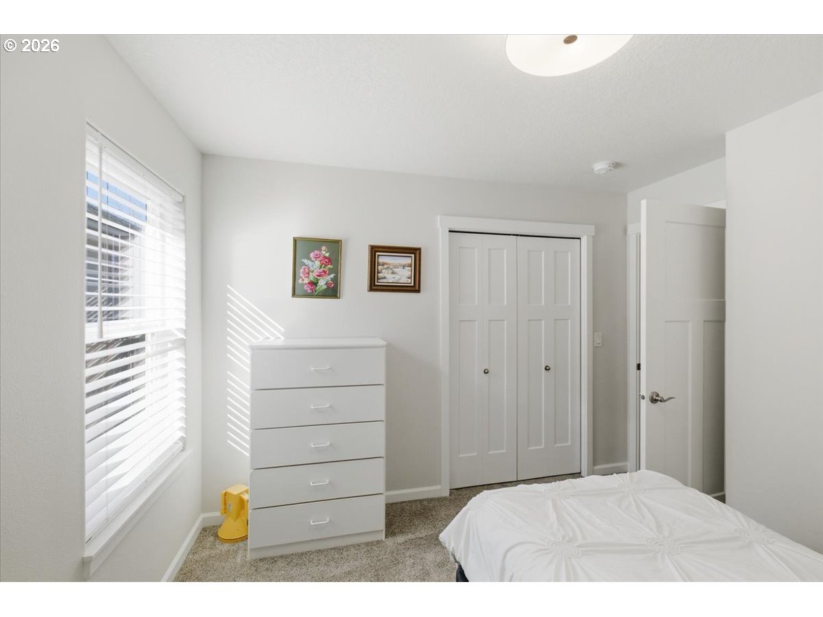 2046 Southeast Academy Street Dallas, OR 97338 - Photo 30 of 47 a bedroom with a bed and a cabinets