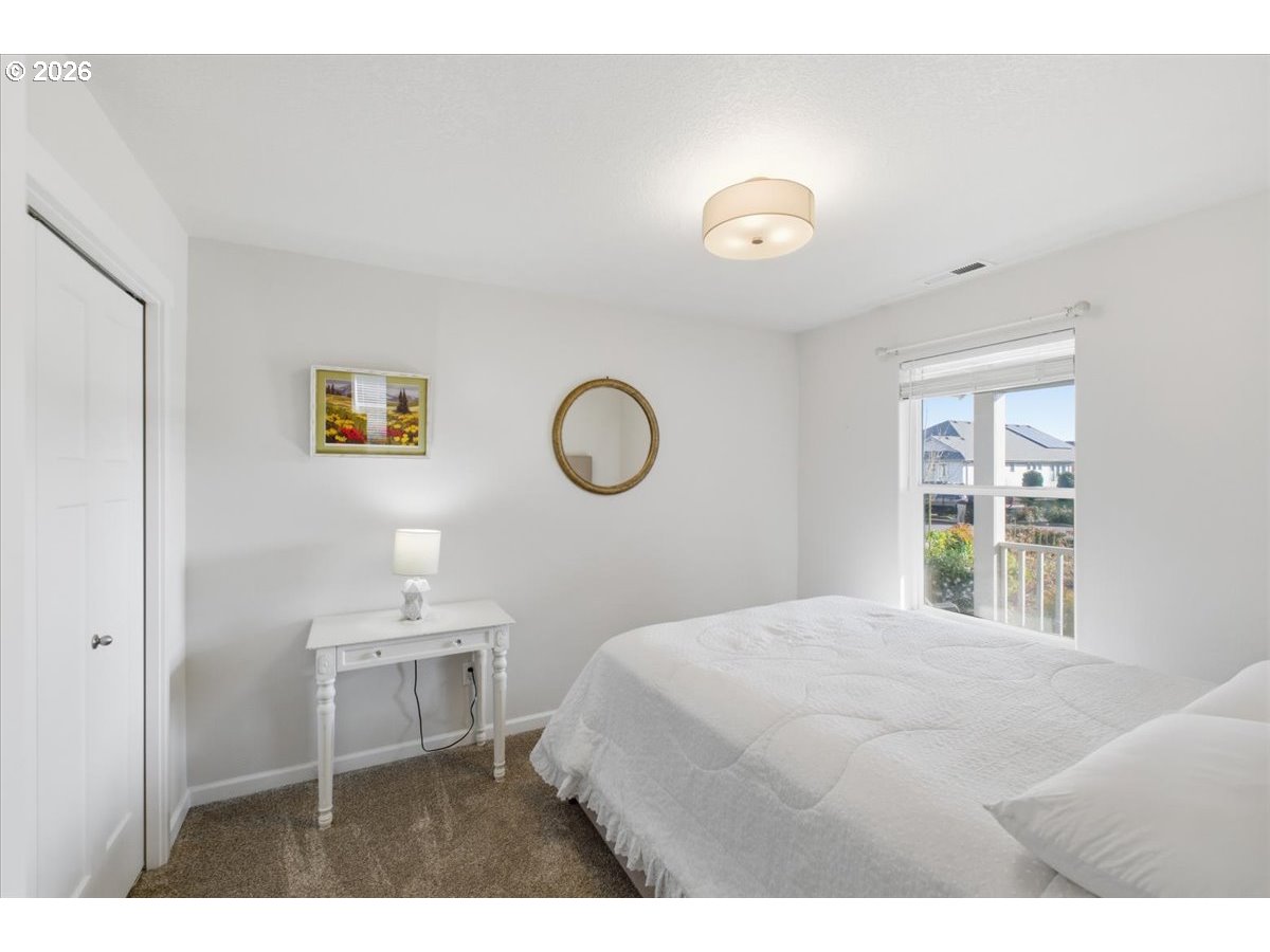 2046 Southeast Academy Street Dallas, OR 97338 - Photo 31 of 47 a bedroom with a bed and a window