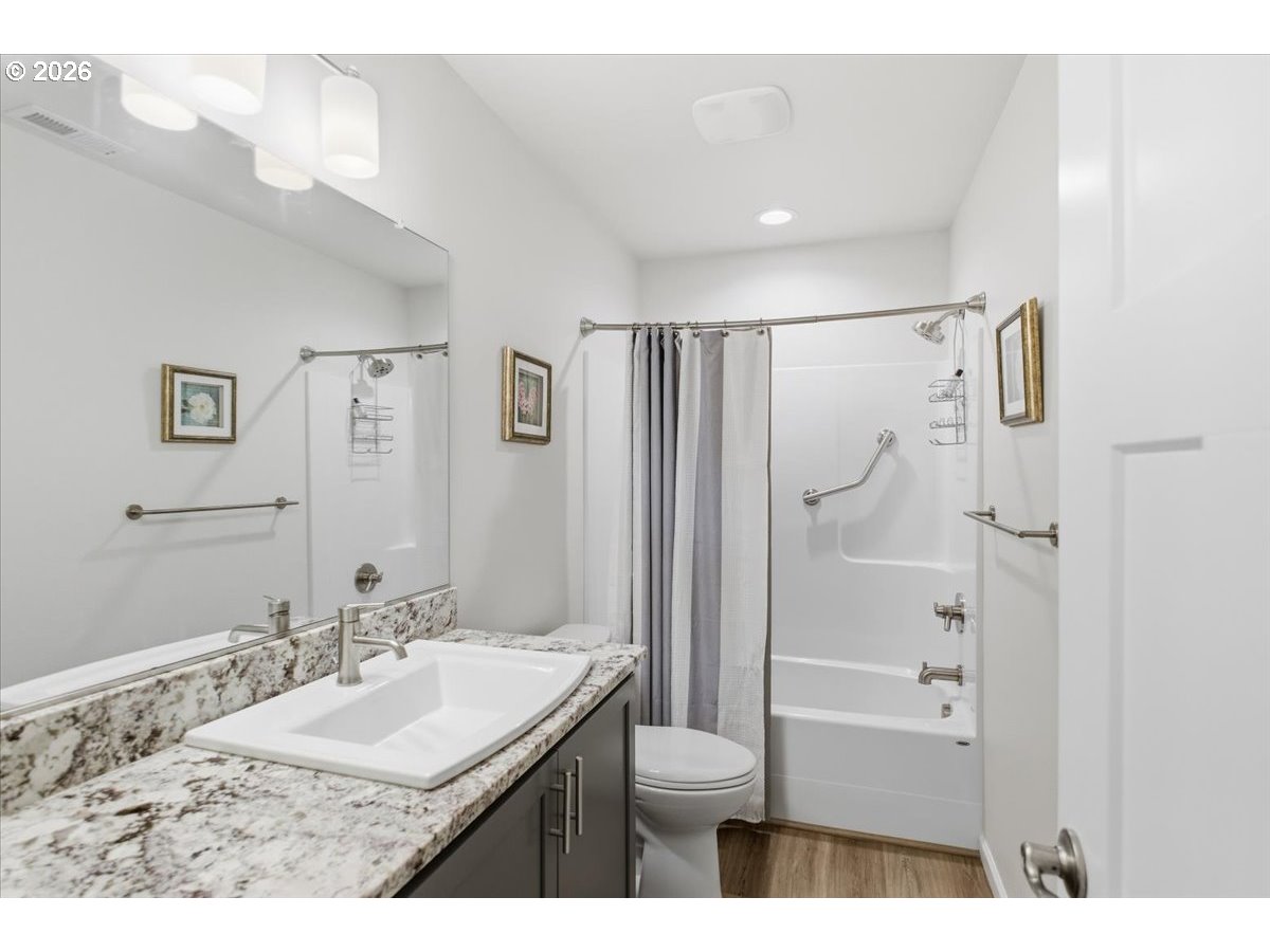 2046 Southeast Academy Street Dallas, OR 97338 - Photo 34 of 47 a bathroom with a granite countertop sink a toilet and shower