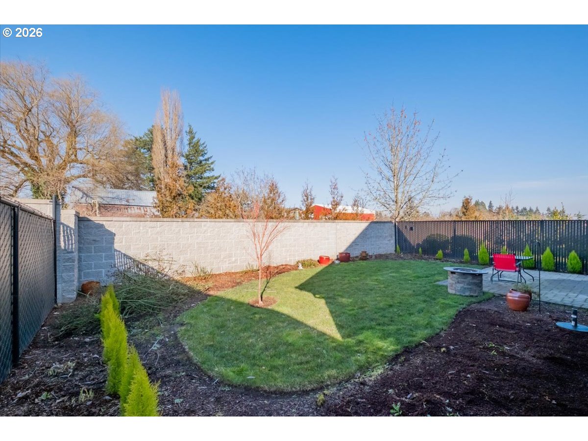 2046 Southeast Academy Street Dallas, OR 97338 - Photo 43 of 47 a view of a garden with a building in the background