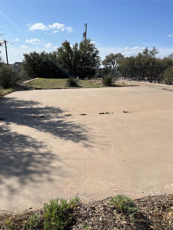 105 Hells Gate Point Strawn, TX 76475 - Photo 5 of 14 View of yard featuring parking pad