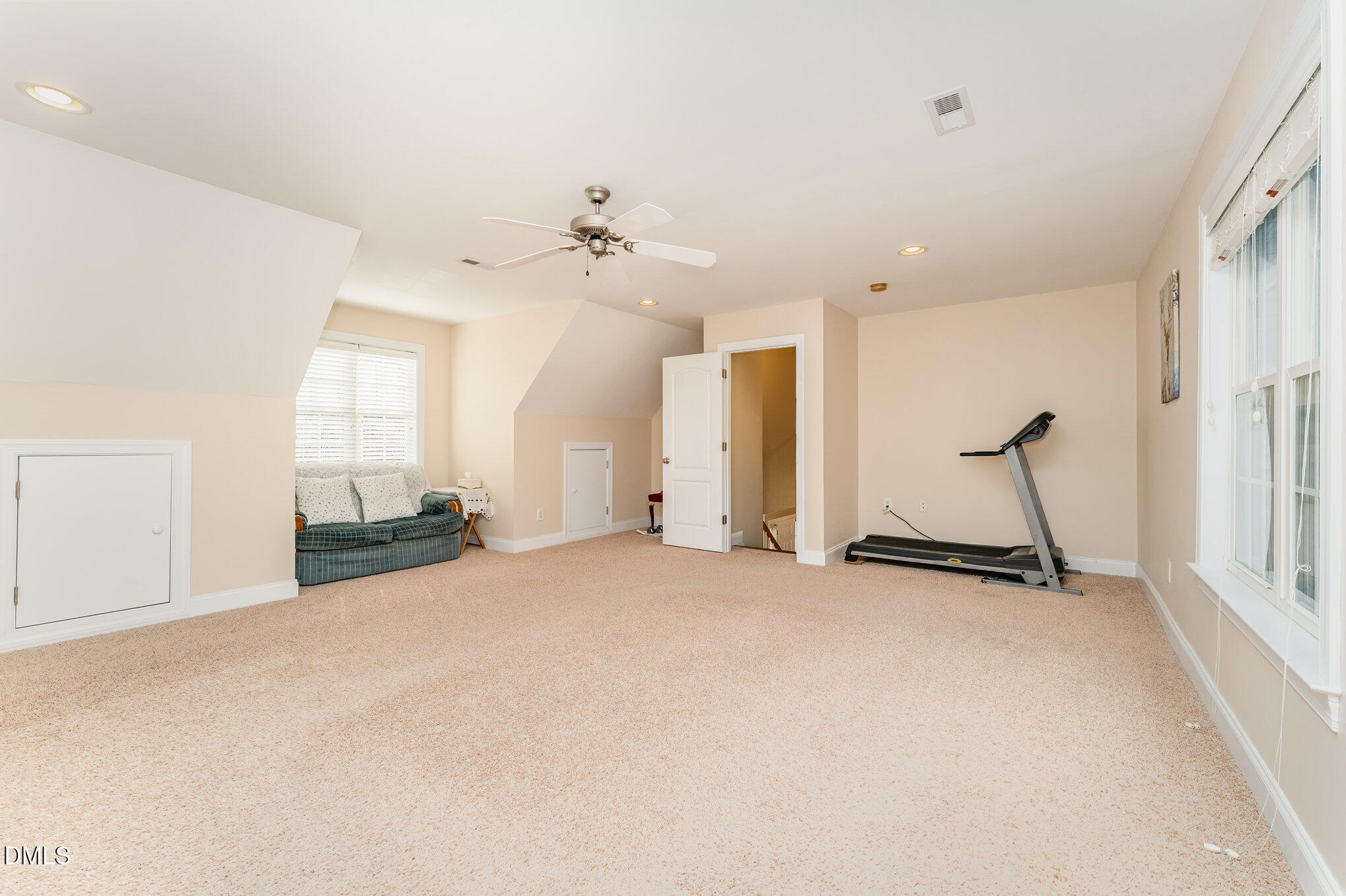 272 Travel Lite Drive Raleigh, NC 27603 - Photo 14 of 30 an empty room with chandelier fan and windows