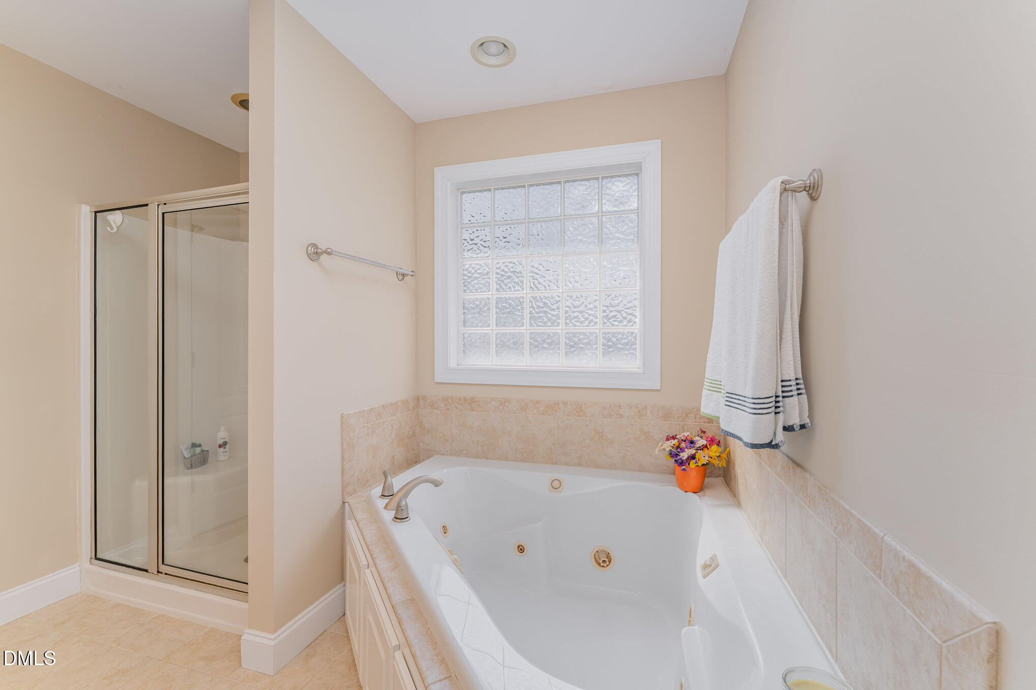 272 Travel Lite Drive Raleigh, NC 27603 - Photo 20 of 30 a bathroom with a tub a window and a shower