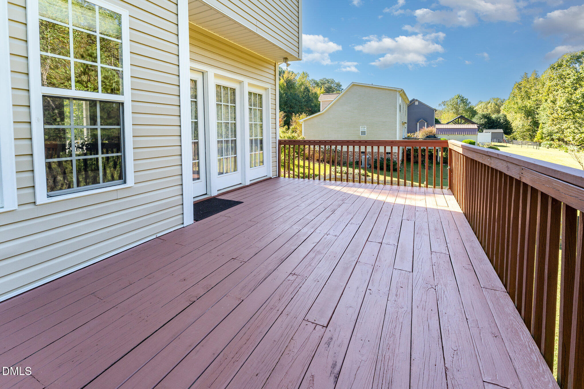 272 Travel Lite Drive Raleigh, NC 27603 - Photo 26 of 30 a view of a wooden deck with a yard