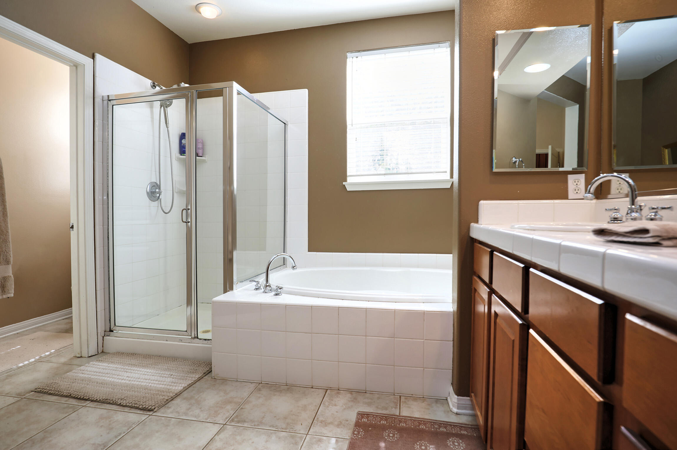 363 Quail Run Road Buellton, CA 93427 - Photo 17 of 25 a bathroom with a bathtub a shower a sink and a large mirror