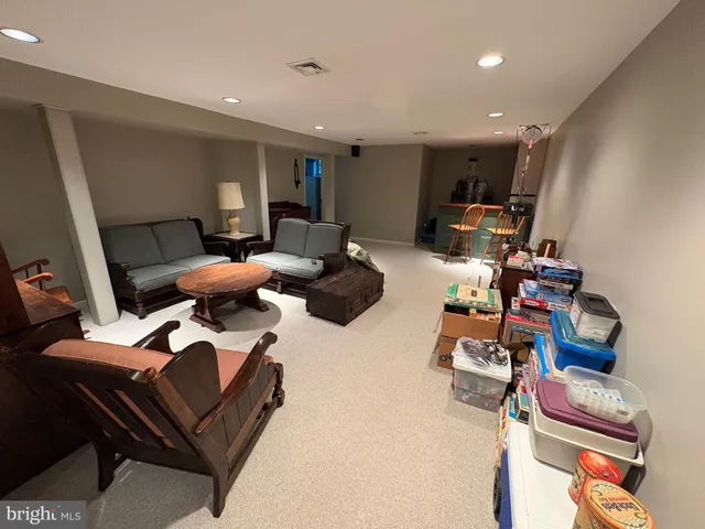 a living room with furniture and a mirror