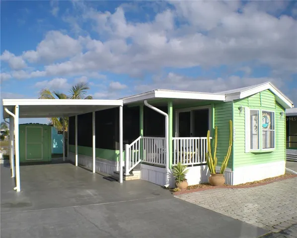 a view of a house with a porch and a floor to ceiling window