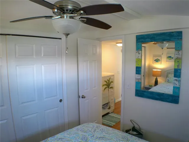 a bedroom with a bed and a view of kitchen