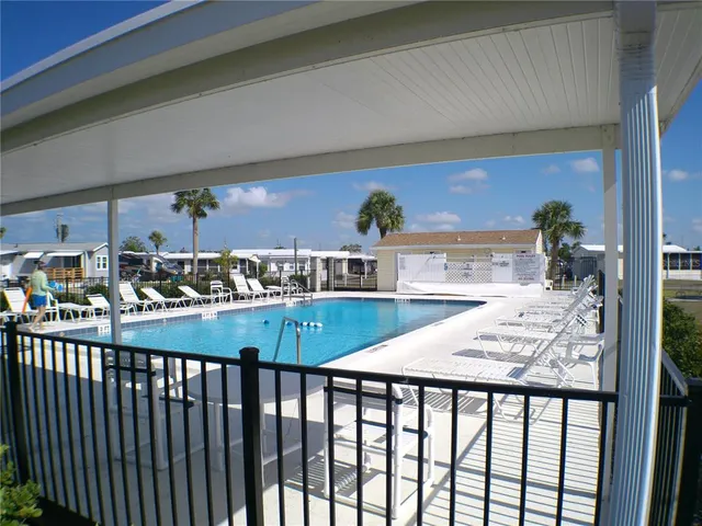 a swimming pool with outdoor seating and yard