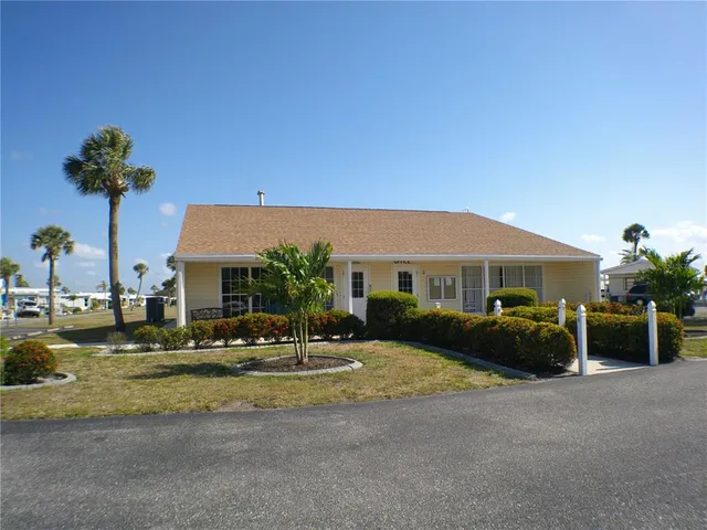 a view of a patio with couches dining table and chairs with wooden floor
