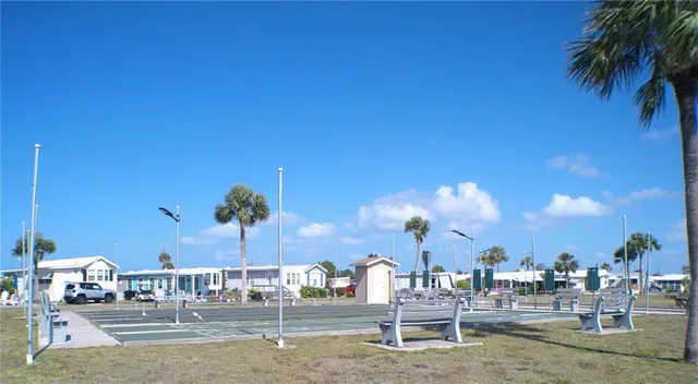 a view of swimming pool with outdoor seating and lake