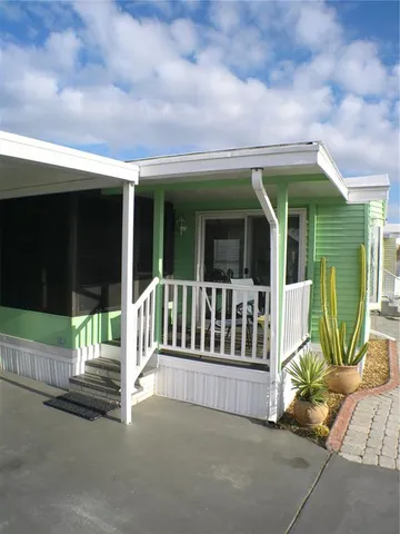 a kitchen with granite countertop wooden floors and white stainless steel appliances